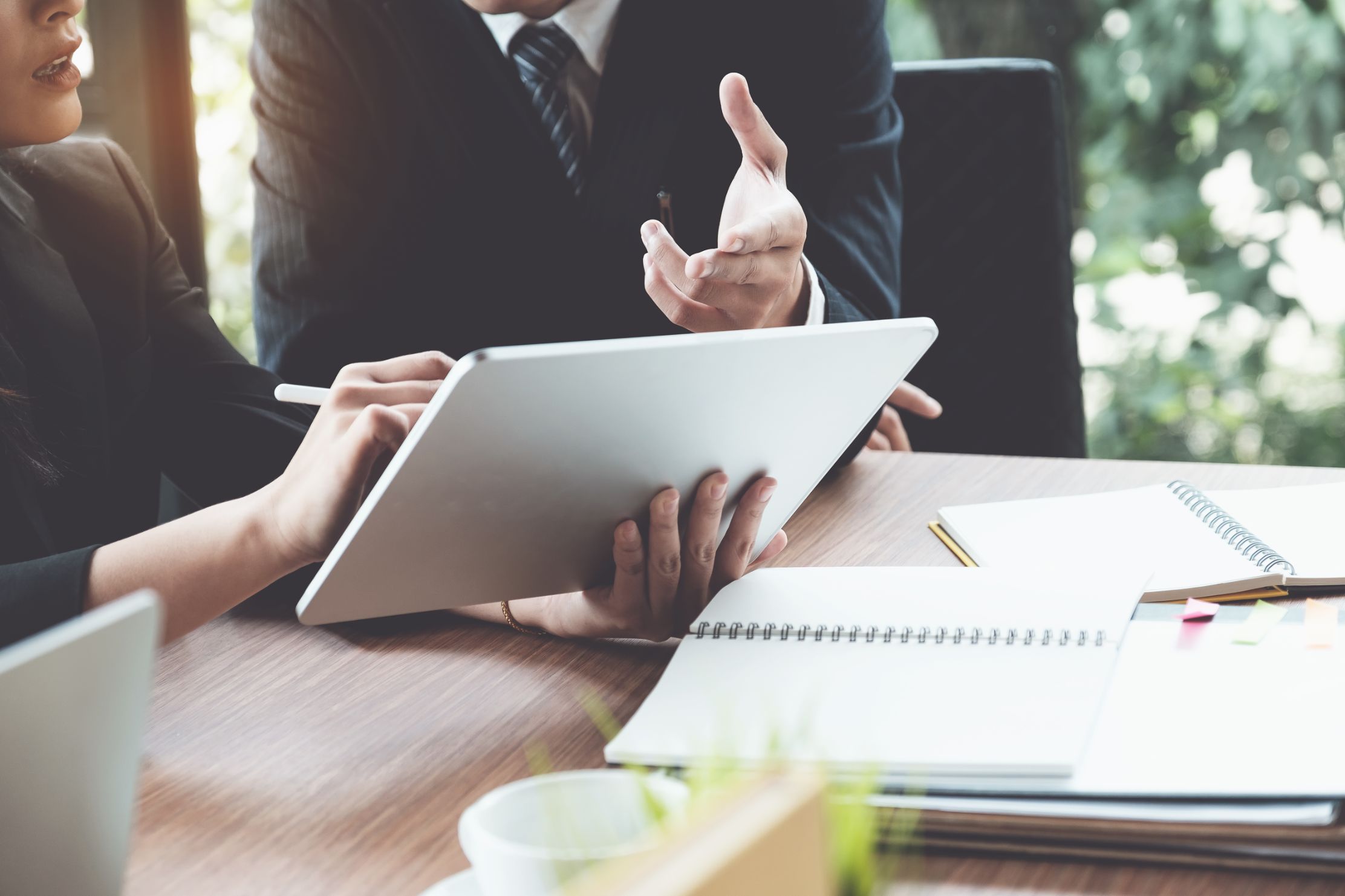 business-woman-and-lawyers-discussing-and-using-digital-tablet-on-wooden-desk-in-office-law-legal-services-advice-justice-concept