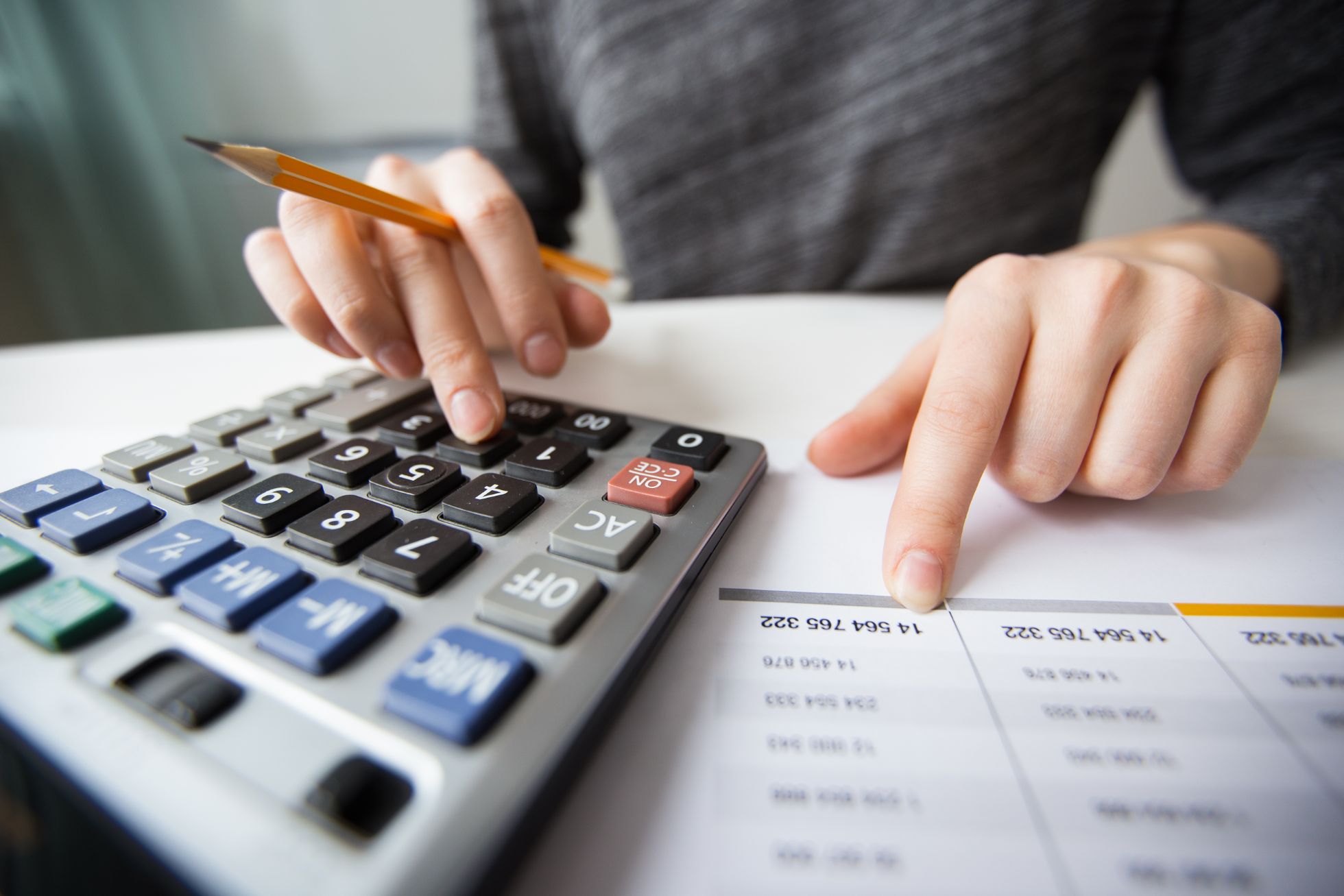 closeup-of-accountant-hands-counting-on-calculator